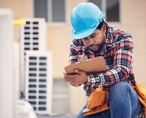 Commercial Hvac Worker With Clipboard Checklist