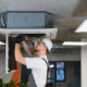 Hvac Technician Repairing Ceiling Air Conditioning System